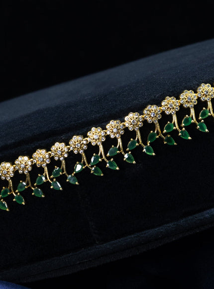 Zircon hip chain floral design with emerald and cz stones in gold finish