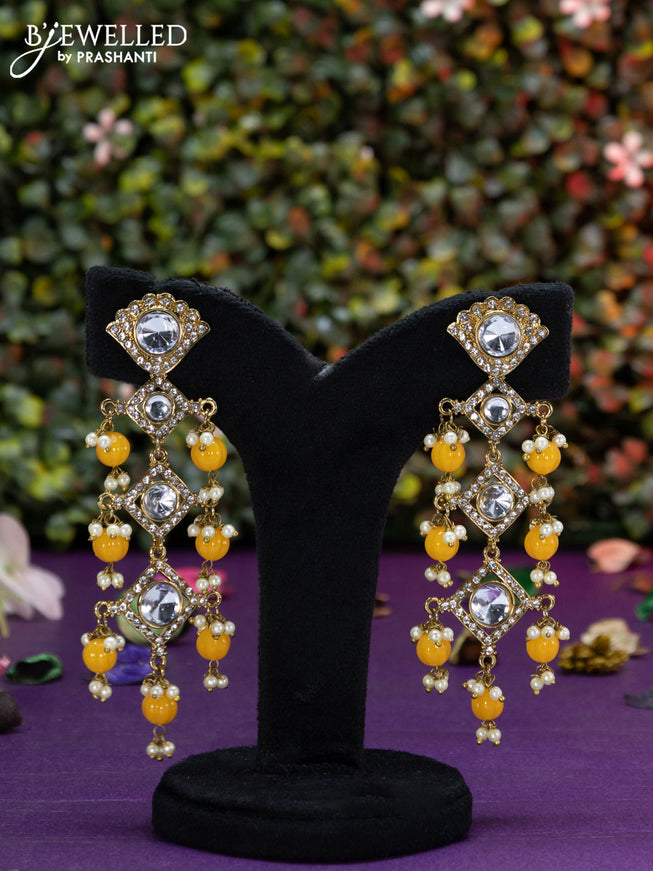 Fashion dangler earrings with kundan stones and yellow beads hangings