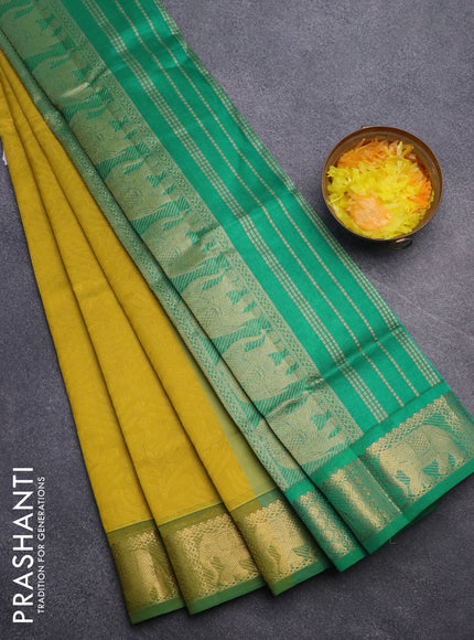 Silk cotton saree dark mustard yellow and green with allover self emboss jacquard and elephant zari woven border