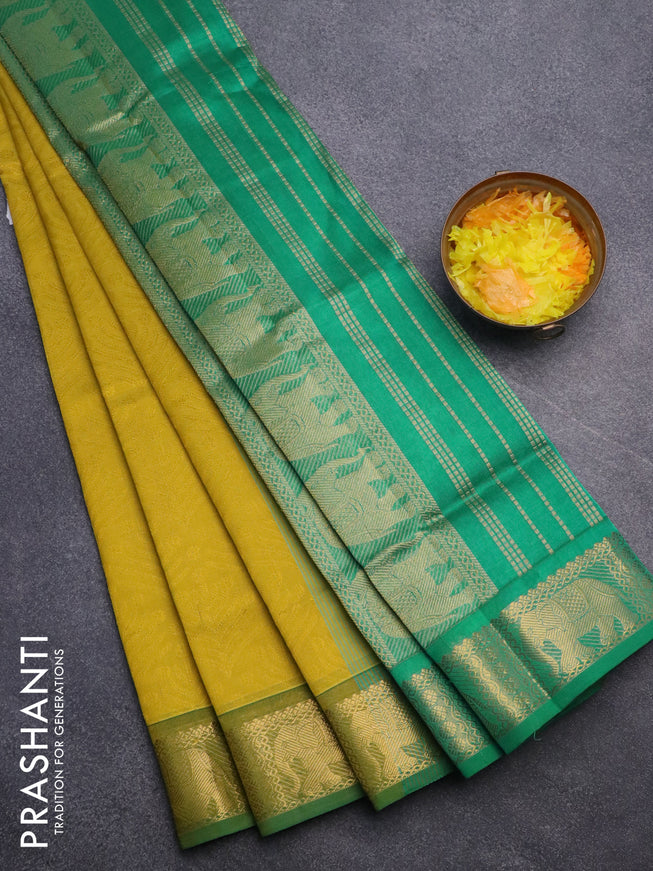 Silk cotton saree dark mustard yellow and green with allover self emboss jacquard and elephant zari woven border