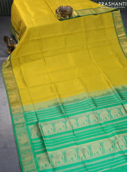 Silk cotton saree dark mustard yellow and green with allover self emboss jacquard and elephant zari woven border