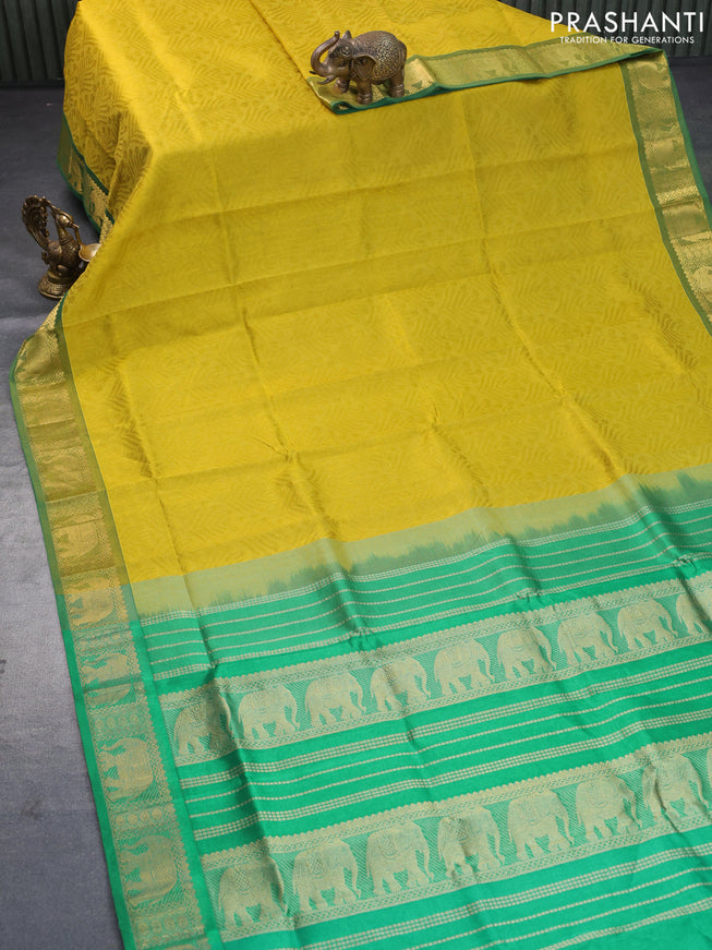 Silk cotton saree dark mustard yellow and green with allover self emboss jacquard and elephant zari woven border