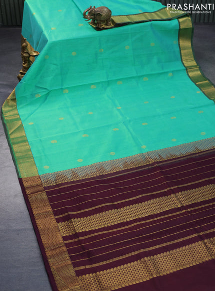 Silk cotton saree dual shade of teal greenish yellow and coffee brown with zari woven buttas and zari woven border