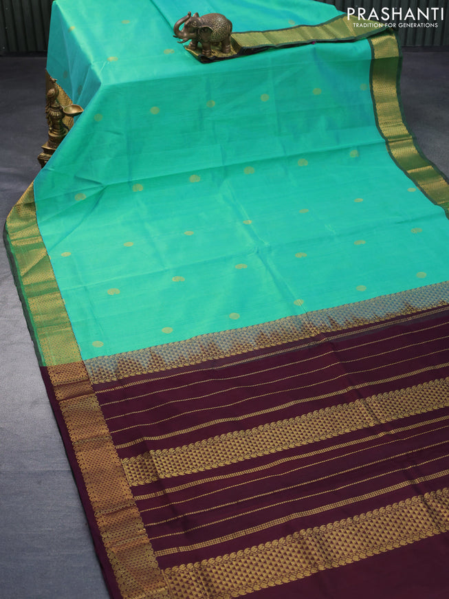 Silk cotton saree dual shade of teal greenish yellow and coffee brown with zari woven buttas and zari woven border