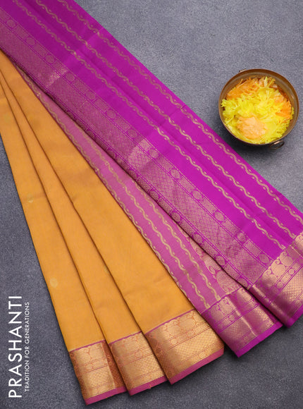 Silk cotton saree dual shade of dark mustard yellow and purple with zari woven buttas and zari woven border