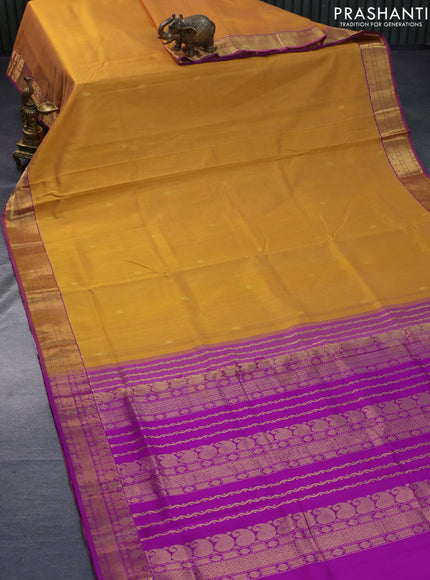 Silk cotton saree dual shade of dark mustard yellow and purple with zari woven buttas and zari woven border