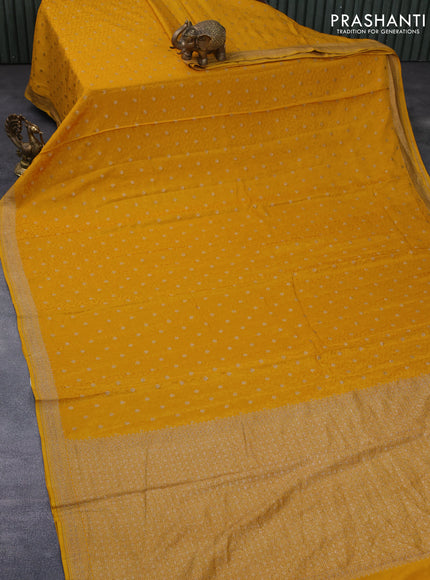 Pure banarasi crepe silk saree mustard yellow with allover self emboss & zari buttas and woven border