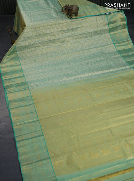 Kanchipuram tissue silk saree dual shade of teal green and teal blue with allover silver zari woven floral brocade weaves and zari woven border