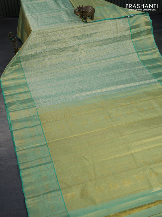 Kanchipuram tissue silk saree dual shade of teal green and teal blue with allover silver zari woven floral brocade weaves and zari woven border