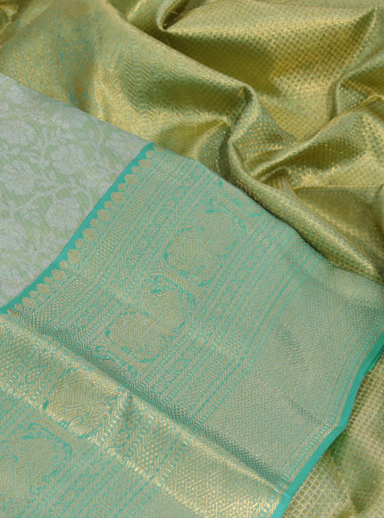 Kanchipuram tissue silk saree dual shade of teal green and teal blue with allover silver zari woven floral brocade weaves and zari woven border