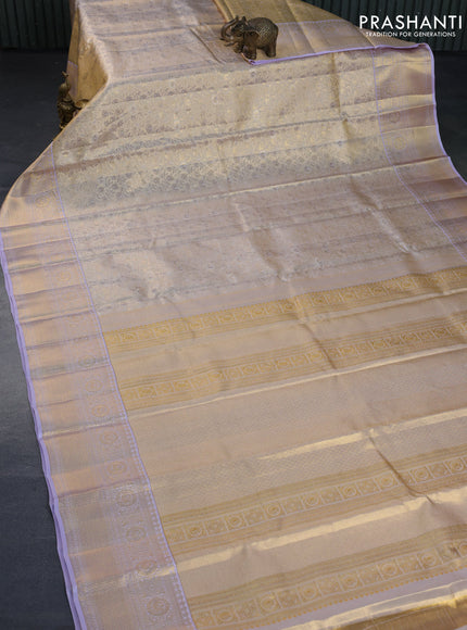 Kanchipuram tissue silk saree dual shade of gold and lavender shade with allover silver zari woven brocade weaves and zari woven border