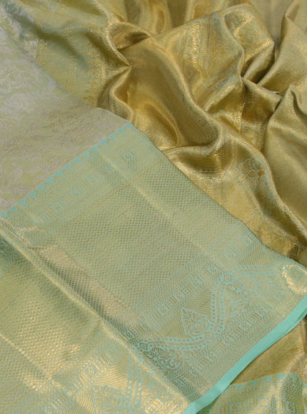 Kanchipuram tissue silk saree dual shade of teal green with allover silver zari woven brocade weaves and long zari woven border