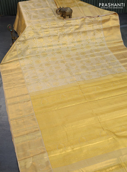 Kanchipuram tissue silk saree sandal and cream with allover silver zari woven brocade weaves and long zari woven border