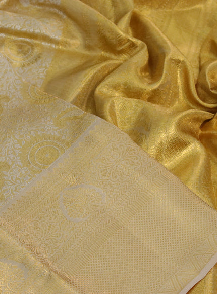 Kanchipuram tissue silk saree sandal and cream with allover silver zari woven brocade weaves and long zari woven border