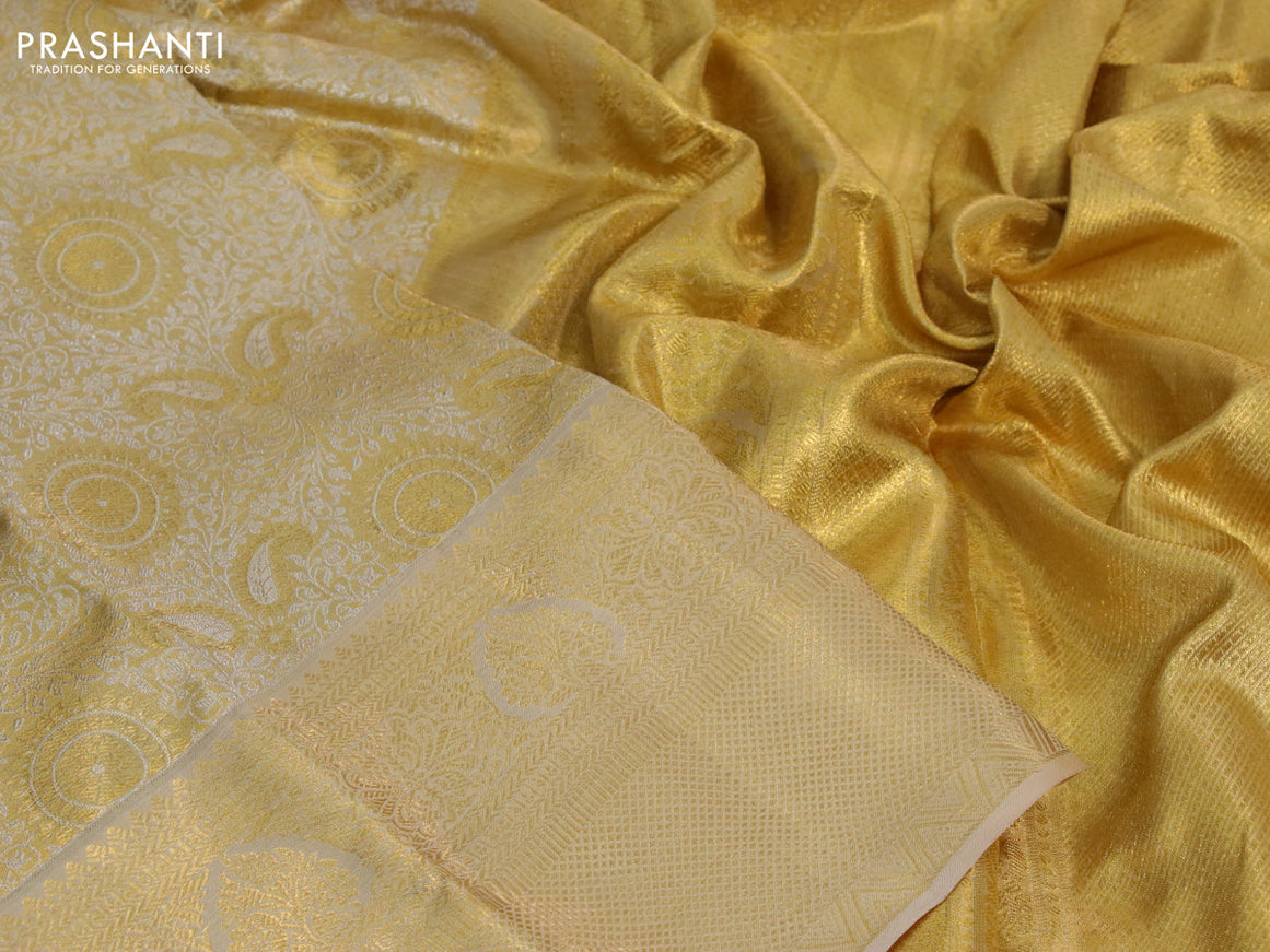 Kanchipuram tissue silk saree sandal and cream with allover silver zari woven brocade weaves and long zari woven border