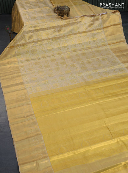 Kanchipuram tissue silk saree dual shade of gold and sandal with allover silver zari woven brocade weaves and long zari woven border