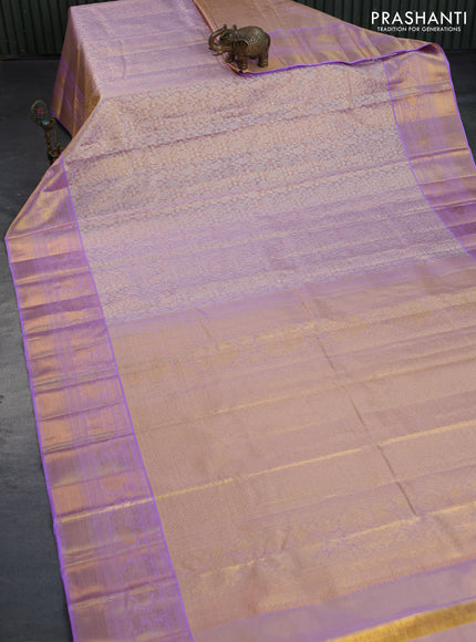 Kanchipuram tissue silk saree dual shade of mild lavender and lavender with allover silver zari woven brocade weaves and long zari woven border