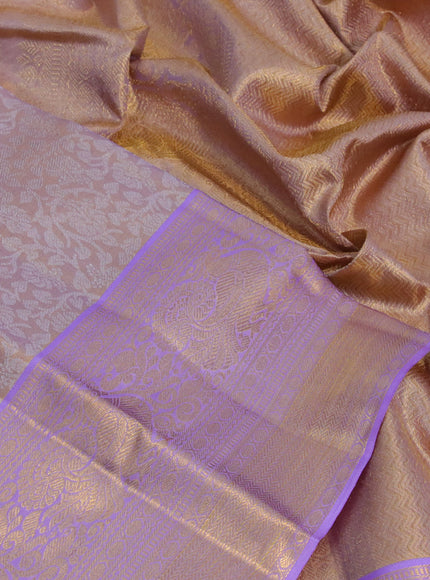 Kanchipuram tissue silk saree dual shade of mild lavender and lavender with allover silver zari woven brocade weaves and long zari woven border