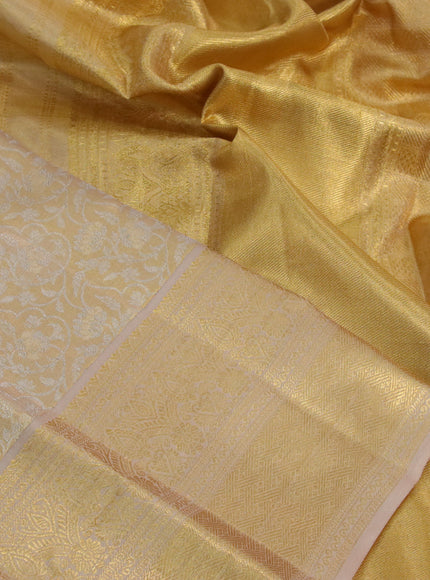 Kanchipuram tissue silk saree gold and dark sandal with allover silver zari woven brocade weaves and long zari woven border