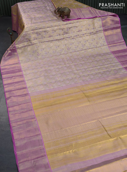 Kanchipuram tissue silk saree dual shade of gold and light pink with allover zari woven brocade weaves and long zari woven border