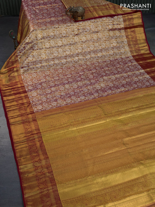 Kanchipuram tissue silk saree dual shade of goldish red and red with allover silver zari woven floral brocade weaves and long zari woven border