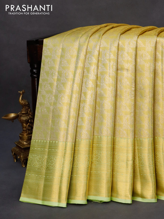 Kanchipuram tissue silk saree dual shade of lime yellow and pista green with allover zari woven brocade weaves and long zari woven border