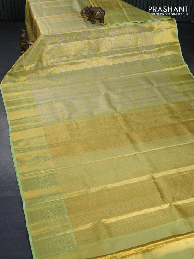 Kanchipuram tissue silk saree dual shade of lime yellow and pista green with allover zari woven brocade weaves and long zari woven border