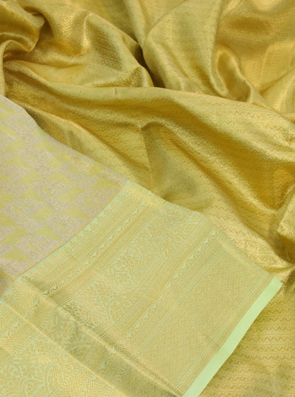 Kanchipuram tissue silk saree dual shade of lime yellow and pista green with allover zari woven brocade weaves and long zari woven border