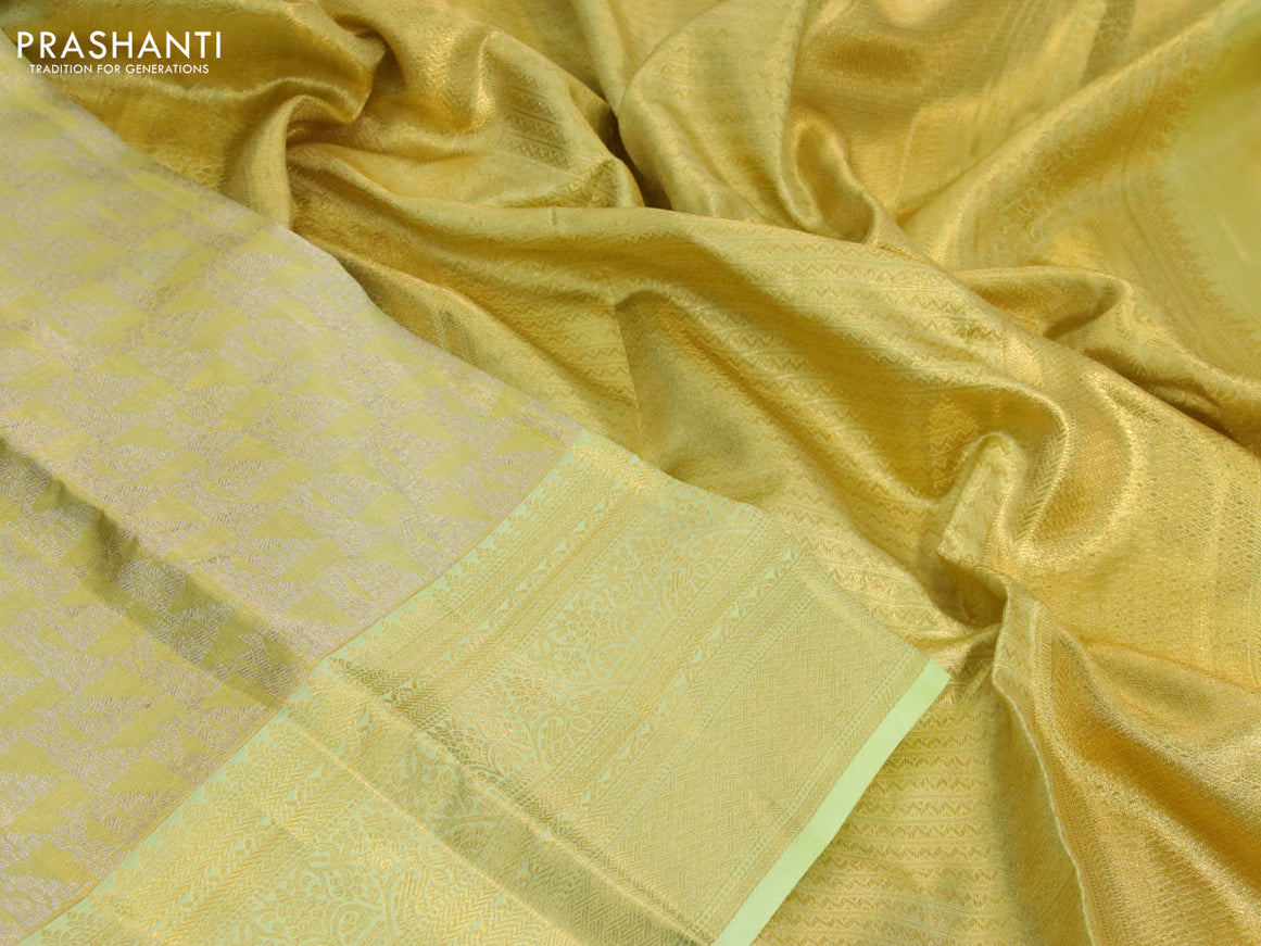 Kanchipuram tissue silk saree dual shade of lime yellow and pista green with allover zari woven brocade weaves and long zari woven border