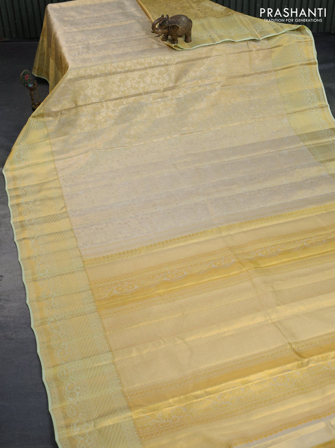 Kanchipuram tissue silk saree gold and mild pista green with allover zari woven brocade weaves and long zari woven border