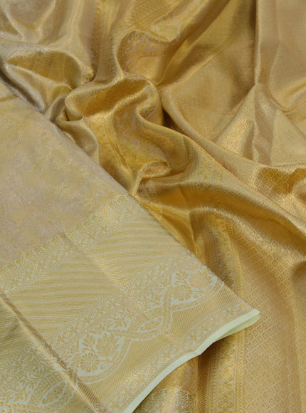 Kanchipuram tissue silk saree gold and mild pista green with allover zari woven brocade weaves and long zari woven border