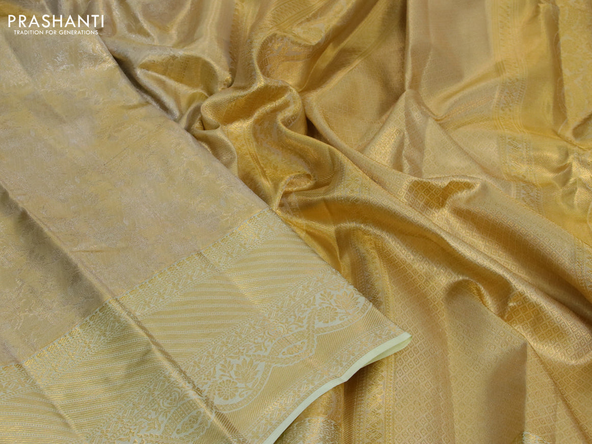 Kanchipuram tissue silk saree gold and mild pista green with allover zari woven brocade weaves and long zari woven border