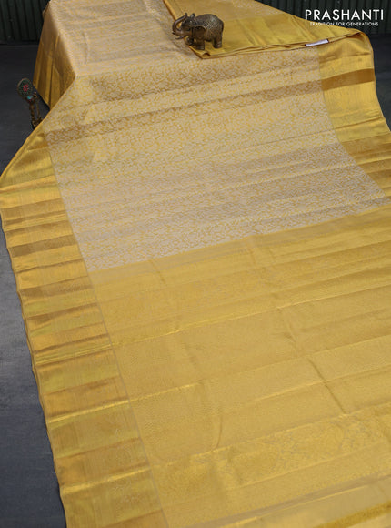 Kanchipuram tissue silk saree gold and sandal with allover silver zari woven brocade weaves and long zari woven border