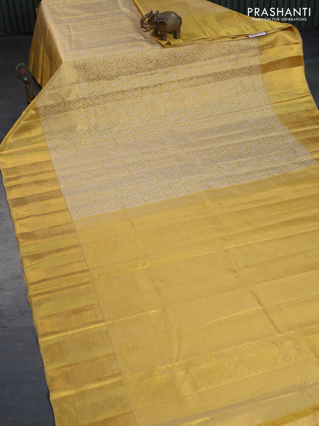 Kanchipuram tissue silk saree gold and sandal with allover silver zari woven brocade weaves and long zari woven border