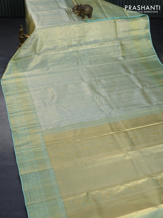 Kanchipuram tissue silk saree dual shade of teal and teal blue shade with allover zari woven brocade weaves and long zari woven border