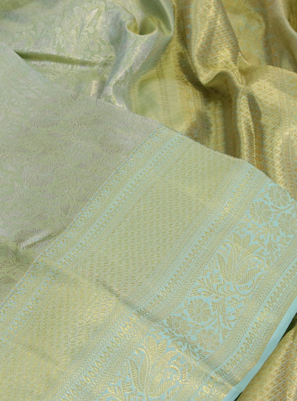 Kanchipuram tissue silk saree dual shade of teal and teal blue shade with allover zari woven brocade weaves and long zari woven border