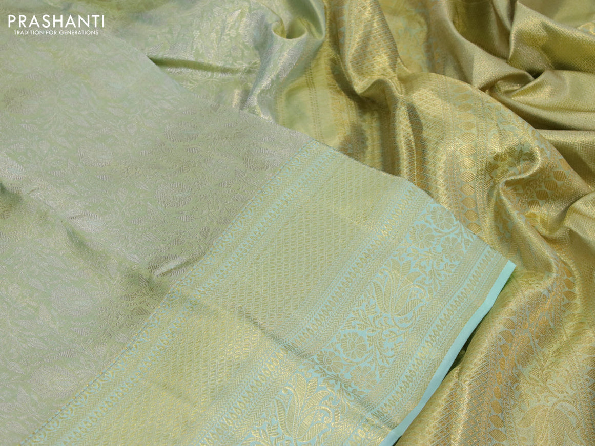 Kanchipuram tissue silk saree dual shade of teal and teal blue shade with allover zari woven brocade weaves and long zari woven border