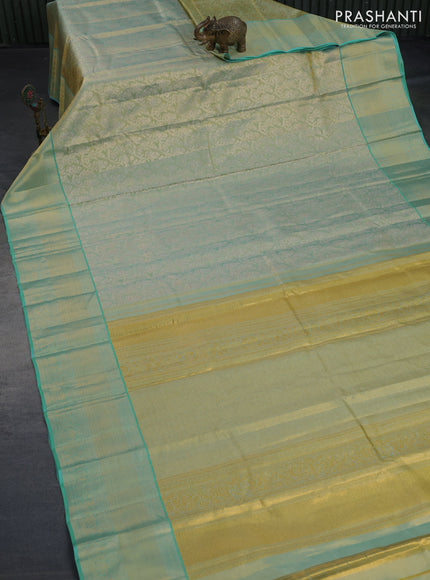 Kanchipuram tissue silk saree dual shade of bluish gold and teal blue with allover zari woven floral brocade weaves and zari woven border