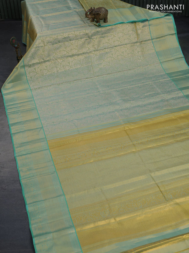 Kanchipuram tissue silk saree dual shade of bluish gold and teal blue with allover zari woven floral brocade weaves and zari woven border