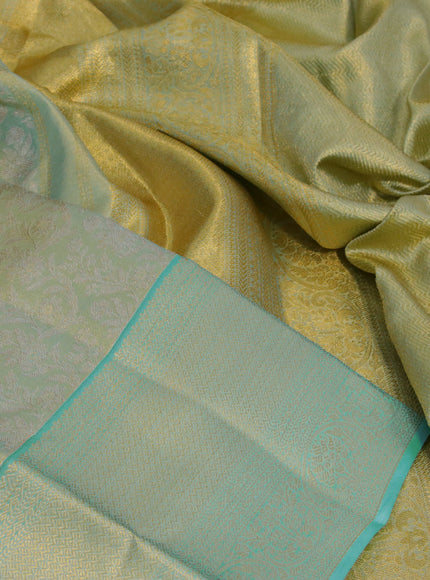 Kanchipuram tissue silk saree dual shade of bluish gold and teal blue with allover zari woven floral brocade weaves and zari woven border