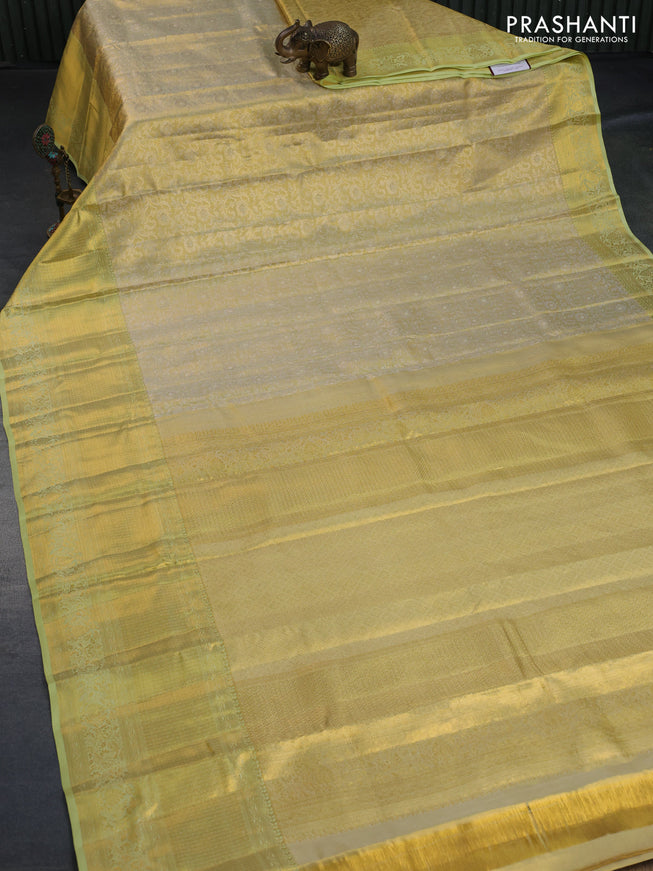 Kanchipuram tissue silk saree gold and mild pista green with allover zari woven floral brocade weaves and zari woven border