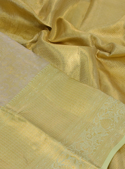 Kanchipuram tissue silk saree gold and mild pista green with allover zari woven floral brocade weaves and zari woven border