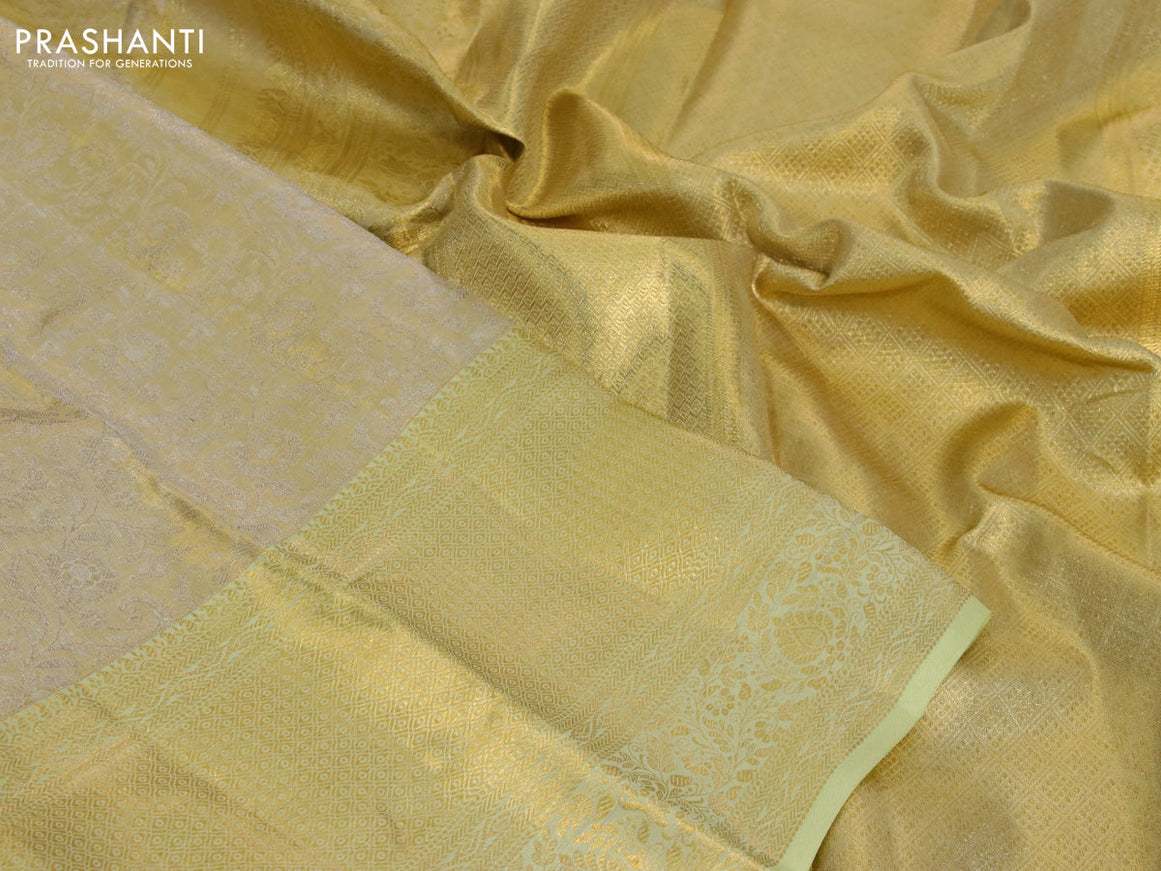 Kanchipuram tissue silk saree gold and mild pista green with allover zari woven floral brocade weaves and zari woven border