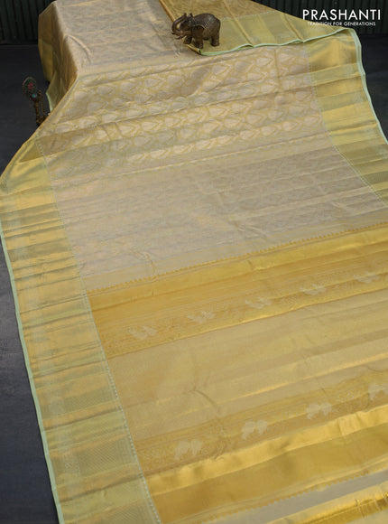 Kanchipuram tissue silk saree gold and mild pista green with allover zari woven brocade weaves and long zari woven border