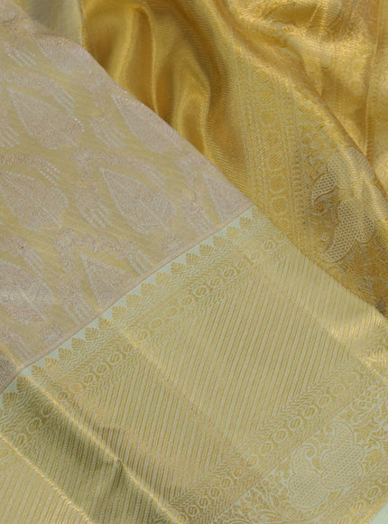 Kanchipuram tissue silk saree gold and mild pista green with allover zari woven brocade weaves and long zari woven border