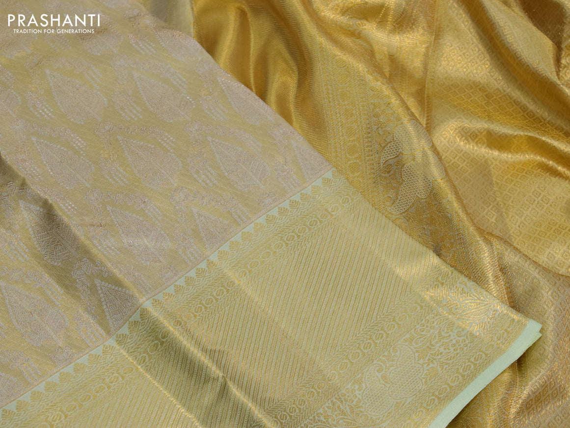 Kanchipuram tissue silk saree gold and mild pista green with allover zari woven brocade weaves and long zari woven border