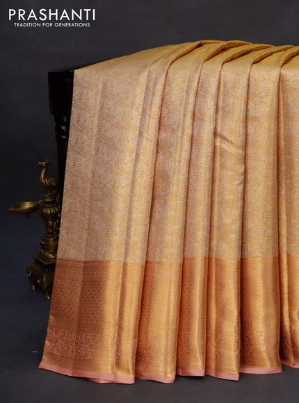 Kanchipuram tissue silk saree gold and pastel peach with allover silver zari woven brocade weaves and long zari woven border