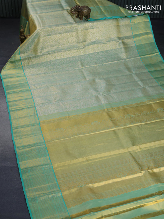 Kanchipuram tissue silk saree dual shade of teal blue with allover silver zari woven brocade weaves and zari woven border