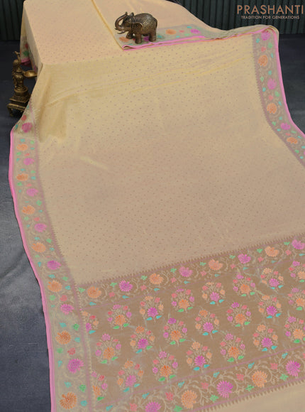 Banarasi georgette silk saree sandal and light pink with allover zari woven butta weaves and zari woven floral design zari woven paithani border