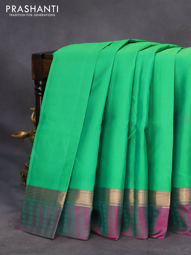 Pure kanchipuram silk saree green and dual shade of purple with plain body and zari woven simple border